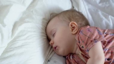 Adorable little girl sleeping in a bed. Childhood concept