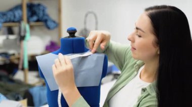 Female dressmaker attach fabric to mannequin. Creating dress design. Tailor industry concept