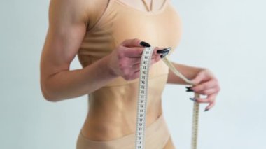 Close up young of a girl with measuring tape over white background
