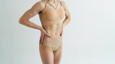 Close up of young woman demonstrating flat stomach. Result of sport and diet.