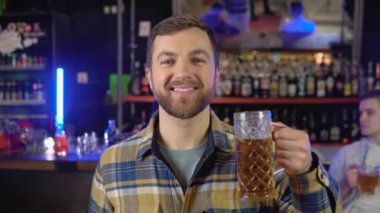Portrait of a man with beer in a pub.