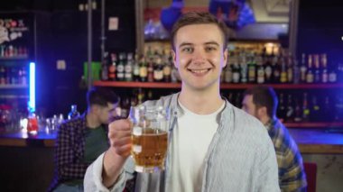 Portrait of a man with beer in a pub.