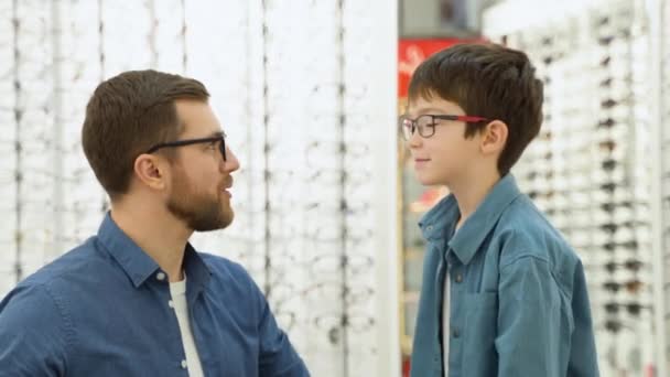 Little Boy His Father Optics Store Ophthalmology Concept — стоковое видео