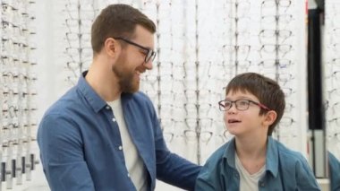 Little boy with his father in optics store. Ophthalmology concept.