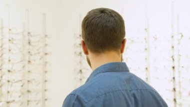 Happy young excited satisfied male customer at optics store.