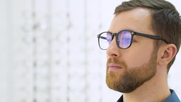 Portrait Handsome Bearded Guy Picking New Specs Optical Shop Looking — Video Stock