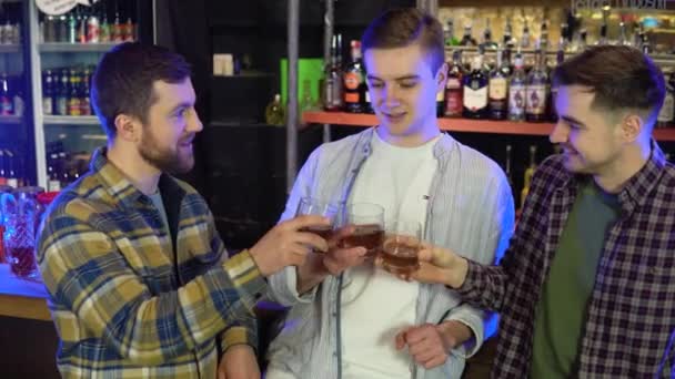 Four Friends Sitting Bar Chatting Pouring Whiskey Glasses — Stockvideo