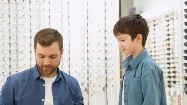 Little Boy Optics Store Choosing Glasses His Father Ophthalmology Concept — Wideo stockowe