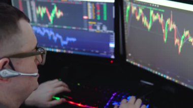 Crypto trader investor analyst broker using pc computer analyzing digital cryptocurrency exchange stock market trading graphs report thinking of investing funds risks doing global analysis.
