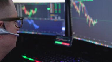 Crypto trader investor analyst broker using pc computer analyzing digital cryptocurrency exchange stock market trading graphs report thinking of investing funds risks doing global analysis.