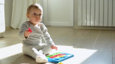 Little girl playing with educational toy. Cute girl playing intellectual toys.