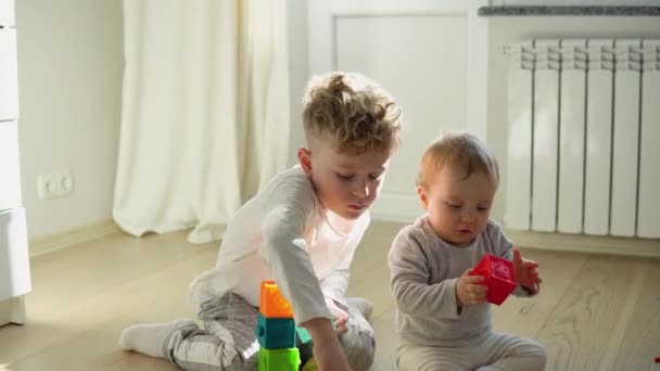 Two Childs Building Tower Block Toys Sitting Floor Sunny Bedroom — Stock videók