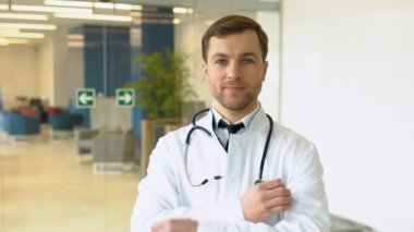 Male doctor standing in clinic in a hallway. Perfect medical service in hospital. Medicine and healthcare concept.
