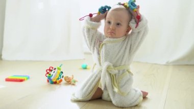 Cute child playing on the floor in nursery