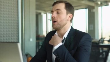 Tired employee overwhelmed with tasks in office
