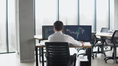Successful trader is working with multiple computer screens full of charts and data analysis and stock broker trading online. Concept of bitcoin and stock market trading