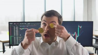 Excited miner broker posing with golden bitcoins in eyes