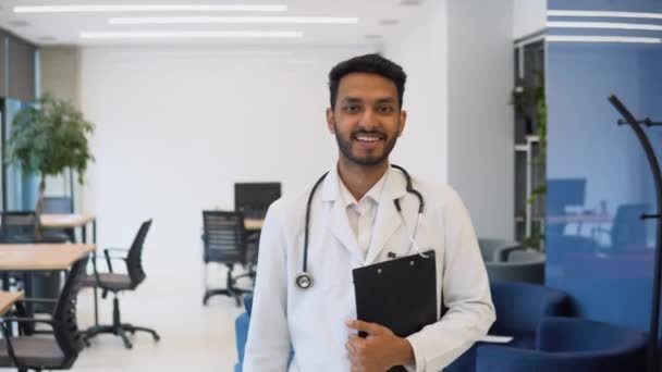 Determined Indian Handsome Doctor Wearing White Coat Stethoscope Walks Hospital — Stockvideo