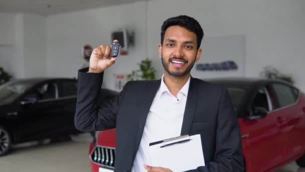 Indian Salesman Standing Dealership New Luxury Car Demonstrating Keys — Stockvideo