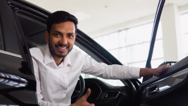 Happy Successful Indian Man Sitting His New Car Auto Showroom — Stockvideo