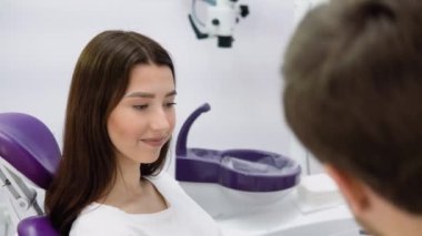 Deneyimli bir doktor genç bir kız hastayla konuşuyor. Tedavi planının tartışılması