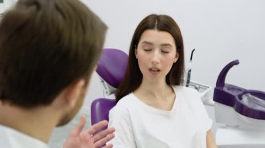 Deneyimli bir doktor genç bir kız hastayla konuşuyor. Tedavi planının tartışılması