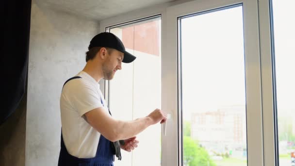 Worker Overalls Installing Window Lock Home Safety Window Lock How — Stock Video