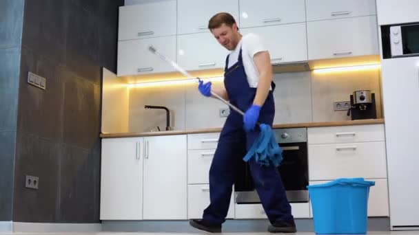 Funny Cheerful Professional Cleaner Mop Depicts Plays Guitar Break — Stock Video