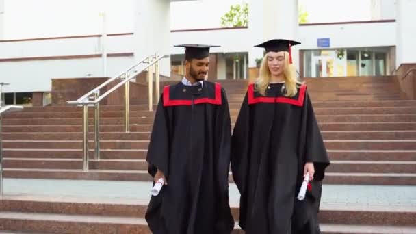 Happy Multiracial Graduates Walking Stairs University Mantles Diplomas Hand — Stock Video