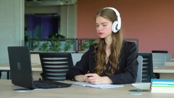 Chica Sonriente Con Auriculares Que Estudian Línea Utilizando Ordenador Portátil — Vídeos de Stock