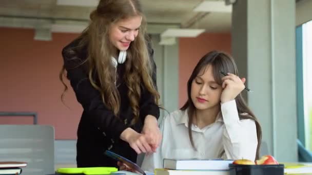 Two Students Doing Homework Together Helping Each Other Sitting Table — Stock Video