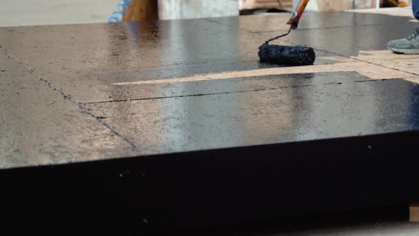 Applying Hot Resin Floor Waterproofing Roller Bucket Resin Black Liquid — Stock video