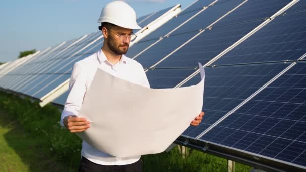 Ein Ingenieur Überprüft Die Konstruktionsunterlagen Der Solarstation — Stockvideo