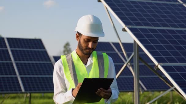 Indian Engineer Checks Design Documentation Solar Station — Stock Video