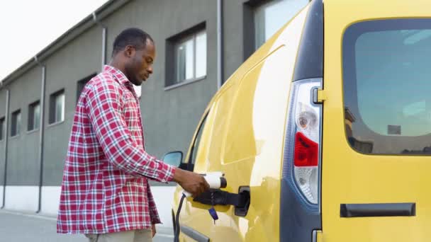Black Man Plugging Charging Cable Cargo Electric Vehicle Charges Batteries — Stock Video