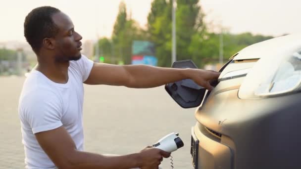 Black Man Charging Cargo Electric Car Warehouse Green Energy Eco — Stock Video
