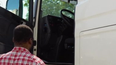 Afrikalı Amerikalı kamyon şoförü kamyonunda oturuyor..