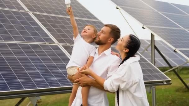 Famiglia Con Lampadina Vicino Pannelli Solari Mostrando Concetto Energia Verde — Video Stock