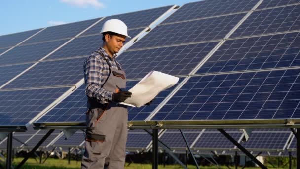 Indian Engineer Checks Technical Documentation Solar Station Installation — Stock Video