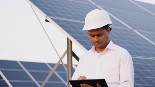 Indian Engineer Using Digital Tablet Maintaining Solar Cell Panels Station — Stock Video