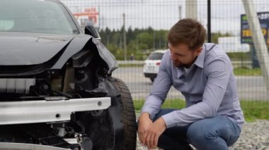 Şehir yolunda trafik kazası geçiren bir adamın önünde yetişkin bir sürücü üzgün bulundu..