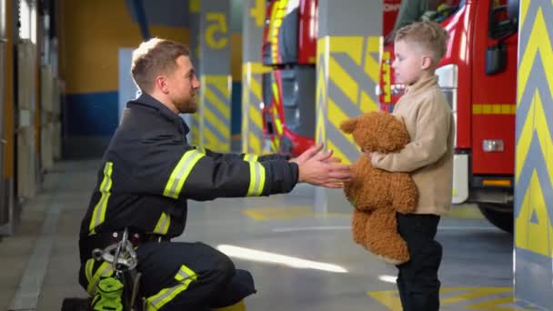 Portrait Rescued Little Boy Firefighter Man Standing Fire Truck — Stock Video