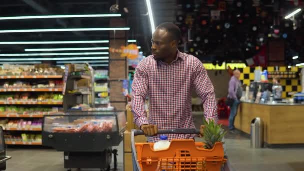 African American Man Walking Shopping Trolley While Doing Shopping Grocery — Stock Video