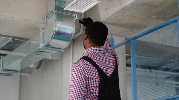 专业的黑色暖气及冷却技师工人完成新组装的空气通风井 商业楼宇的空气气候控制及过滤 — 图库视频影像