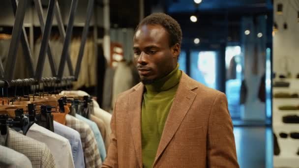 Black Man Choosing New Clothes Store — Stock Video