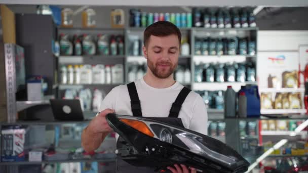 Seller Overalls Gives Client New Automotive Headlight — Stock Video