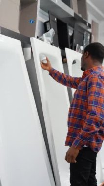 Genç siyah adam dükkanda banyo yapmayı seçiyor.