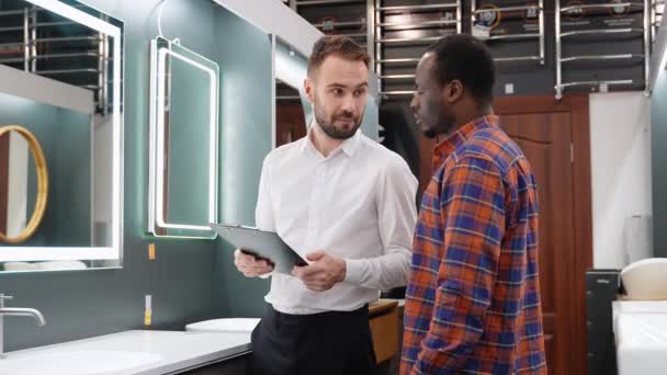 Young African American Man Choosing New Bathroom Furniture Plumbing Shop — Stock Video
