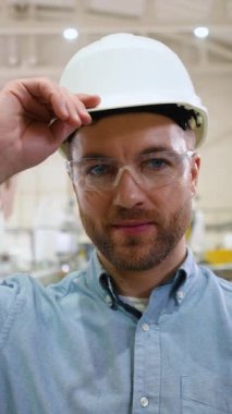 Kendine güvenen mühendis, üretim bandından koruyucu kaskı çıkardı.