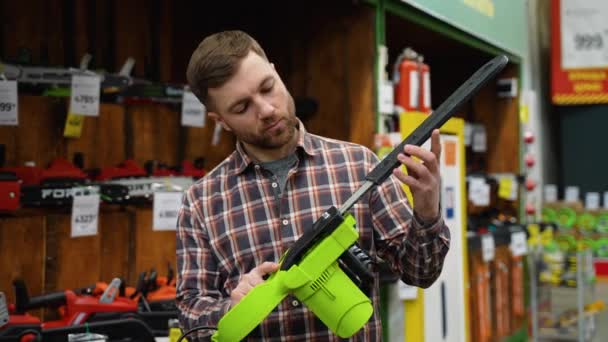 Mann Kauft Neue Kettensäge Werkzeugladen — Stockvideo